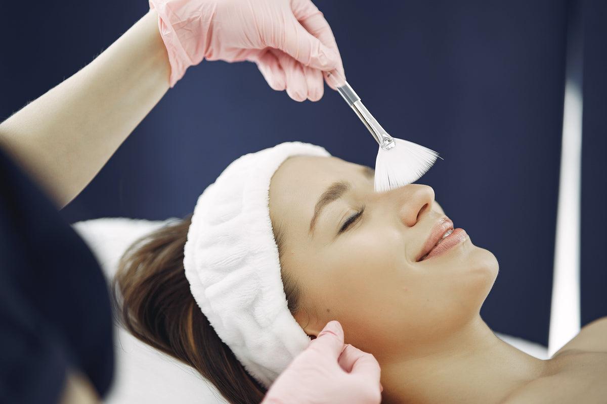 Woman receiving a relaxing facial treatment at a spa before her wedding
